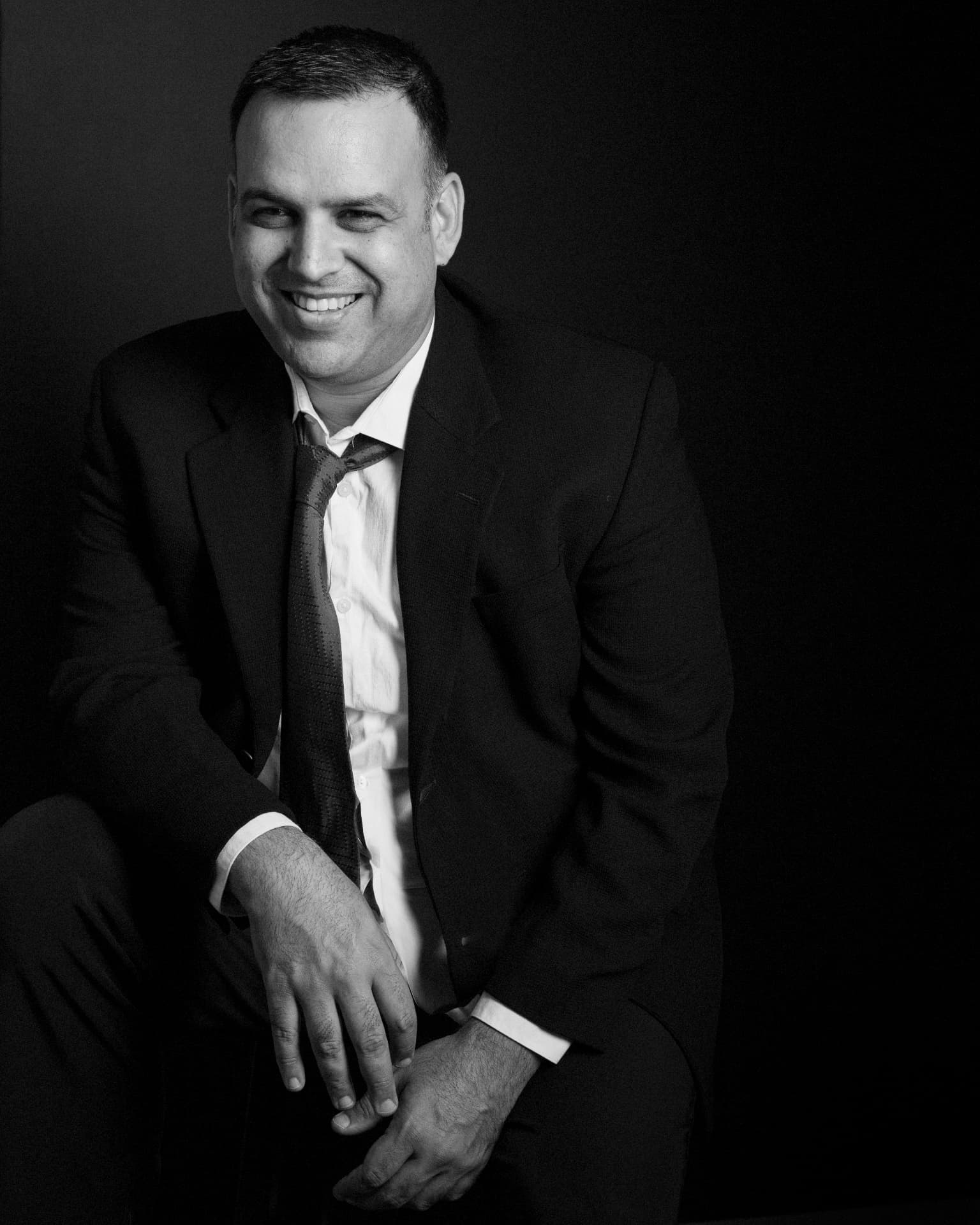 Bob Minhas seated, looking away from the camera